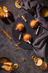 Homemade orange ice cream on a dark background with Ice cream spoon from stainless steel, flat lay, top view