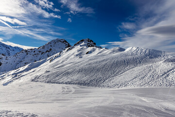 Sunny day and lots of snow at ski resort in the Swiss alps of the Vallees, Switzerland
