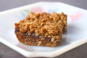 date fruit chocolate bar in a plate on table 