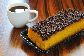 Carrot cake with cup of coffee, typical breakfast in Brazil.