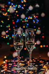 Two glasses of champagne on the background of festive Christmas lights. Glass for wine. bokeh. Christmas. New Year