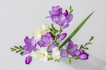 delicate bouquet of lilac and white freesia flowers close-up on a white background
