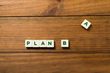 Phrase PLAN B made up of pieces with letters.