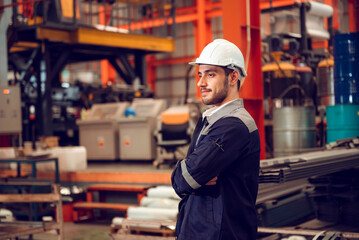 Smart factory worker engineering manager working at industrial worksite , wearing hard hat for safety.