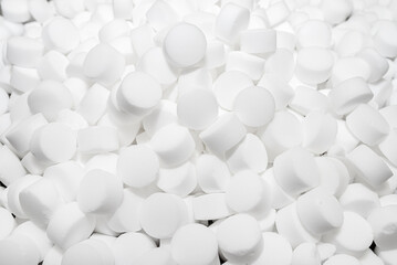 Background made of salt tablets for a water softener, large round cubes.