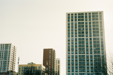 Naklejka premium modern architecture office buildings houses and trees in the evening in the city film shooting