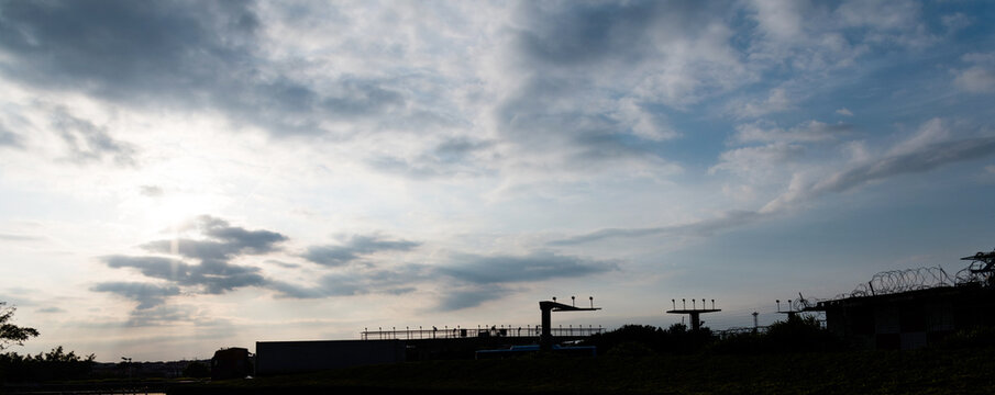 Radio antenna with cloudy sky at airport