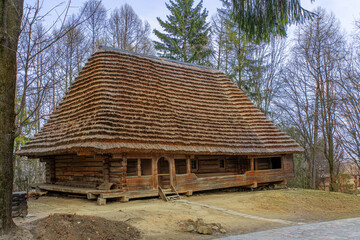Old traditional wooden house in the village on a sunny spring day.