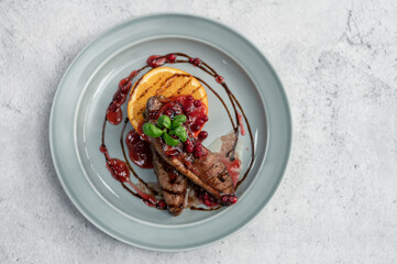 Tasty duck breast with orange and berries