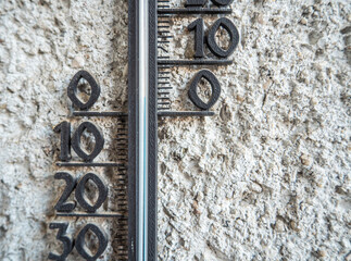Outdoor thermometer on a concrete wall
