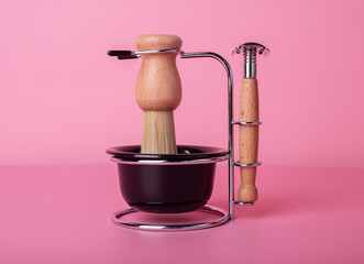Shaving kit for men, razor, brush, cup for foam in vintage retro style. Grooming set on pink background. Hygiene and face care concept.