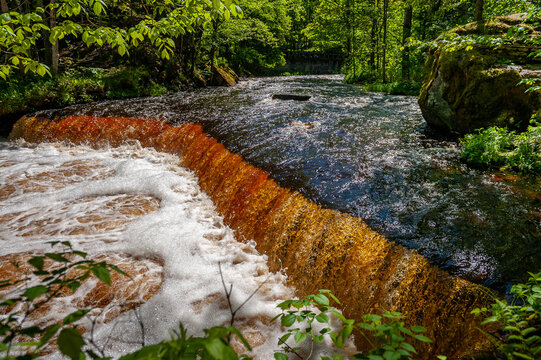Amber waterfall. Nommeveski cascade on the river Valgejogi in Lahemaa National Park, Estonia ( Nõmmeveski, Valgejõgi.) Landscape on a spring sunny day. Panorama.