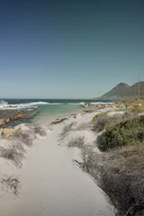 Deurstickers Beautiful view of the rocky sandy beach in Fish Hoek coastal town, Western Cape © Floris Tils/Wirestock Creators