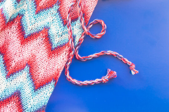 Crocheted dress made of red, pink, blue threads with a zigzag missoni pattern