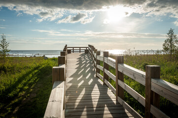 A wooden boardwalk beach access leads through meadow to an observation deck and Baltic beach. Kabli...
