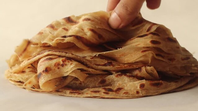 Arranging the layered Parotta or Porotta on to a plate