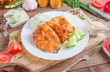 Grilled chicken meat skewers with fresh vegetables on a white plate on a dark wooden background