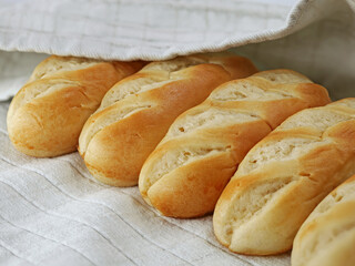 french milk bread buns on gray kitchen towel, close up of delicious french food