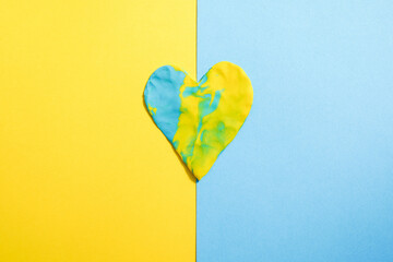 The symbol of the national flag of Ukraine in the form of a heart on the table. Concept