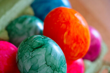 Selective focus, multi-colored Easter eggs in a cardboard package.