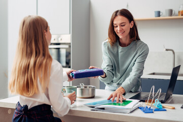 Girl is going to school her mother is preparing breakfast