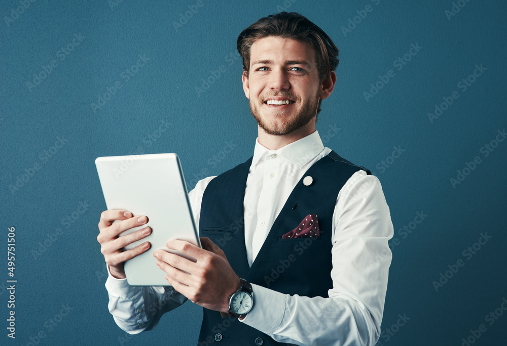 Poster technology keeps me ahead of the curve. studio shot of a handsome young businessman using a tablet a