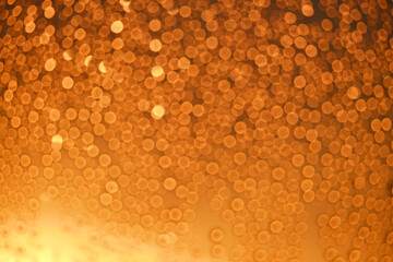 Blurred background window with drops water and bokeh red sun at sunset