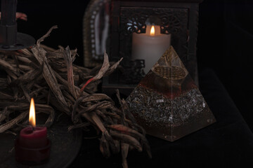 Tarot card spread on a nature display. Hand made tarot cards on a dark wooden table surrounded with dried herbs, blue flowers, white candles. Blue cards.