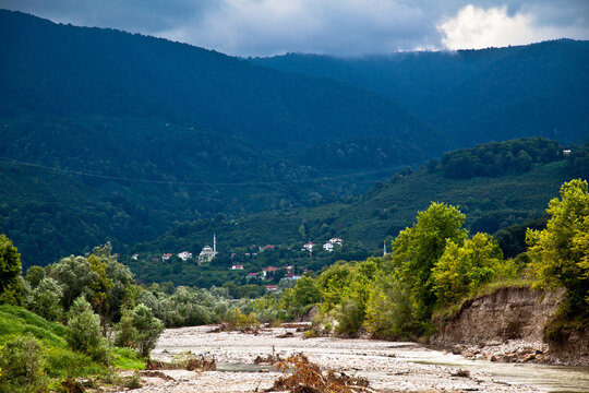 Calmly flowing, clean and crystal clear river and big mountains