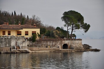 Fototapeta na wymiar Calm sea and part of Croatian coast with house and pine tree on Adriatic Sea