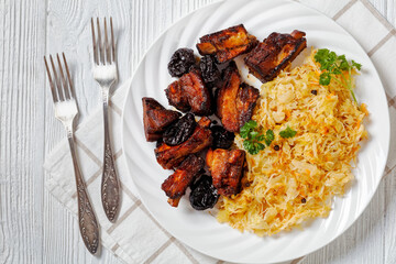 braised sauerkraut with pork and prunes on plate