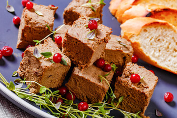 liver pate cubes on plate with toast and berries