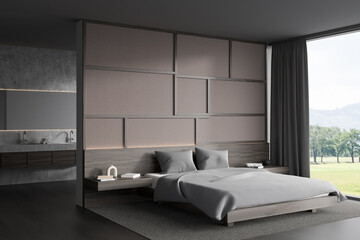 Grey hotel interior with sink and bed near window with countryside