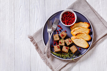 liver pate cubes on plate with toast and berries