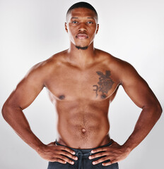 Better than your coffee. Studio portrait of a shirtless handsome young man posing against a white background.