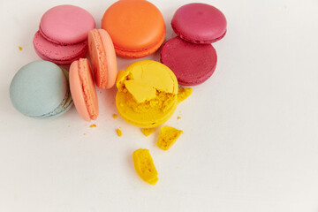 blanks halves for macaroon cakes of different colors lie next to each other with the crumbled part