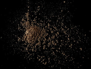 Fototapeta na wymiar Organic linseed protein powder pile isolated on black, top view 