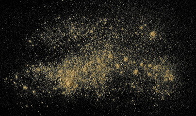 Ginger root powder isolated on black, top view