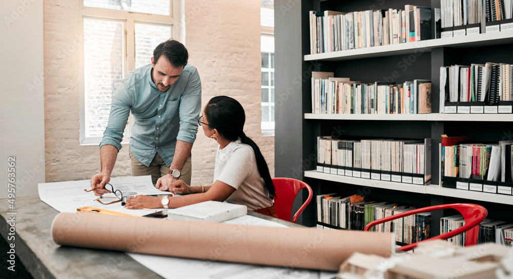 Poster Technology is the cherry on top of their expertise. Cropped shot of two aspiring young architects using a digital tablet while working together in a modern office.