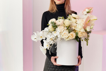 the girl is holding a large bouquet of white flowers in a box