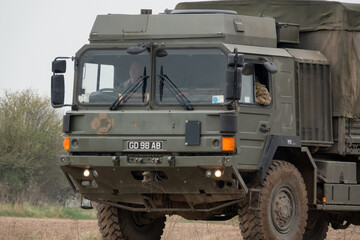 British army MAN SV 4x4 army logistics lorry vehicle truck driving along a dirt track in action on a military exercise