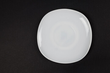 Top view white plate isolated on black