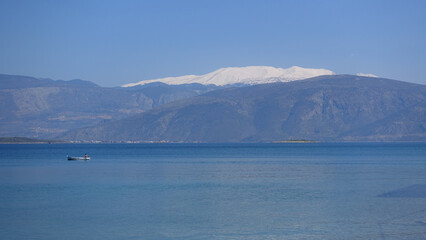 Fototapeta na wymiar Mount Parnassus covered in snow as seen from traditional and picturesque village of Galaxidi famous for marine history and neoclassic architecture, Greece