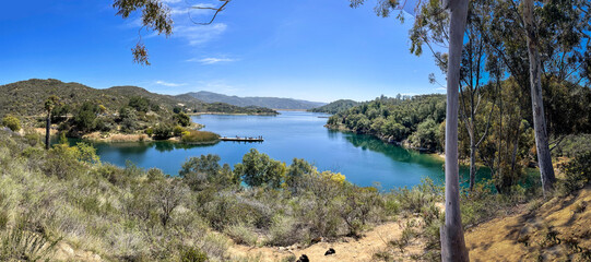 Dixon lake surrounded by green trees and bushes in background of greenery mountains in Escondido