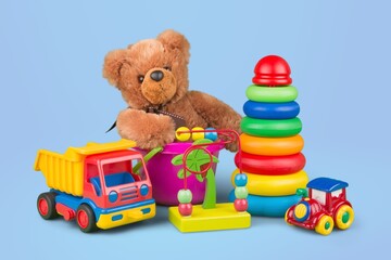 Stack child toys collection on blue background. Bear,  plastic and fluffy educational baby toy set.