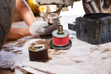 The process of draining oil from a motorcycle engine. Engine oil upgrade.