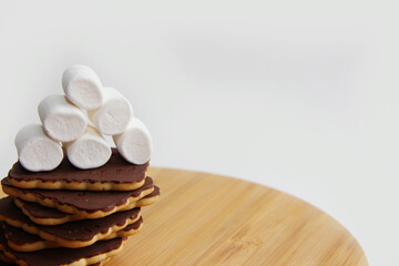chocolate cookies and marshmallows on a wooden board. handmade chocolate dessert