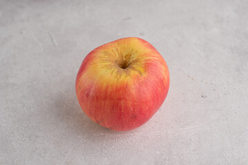 Fresh red apple on grey background. Food ingredients for healthy eating lifestyle