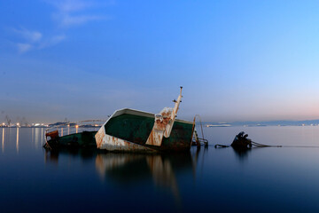 a sunken ship at sea, rusty old ship