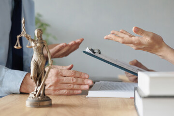 Fototapeta premium a female lawyer at a meeting with a male client in the office of the law office, legal advice online. resolution of disputes of the family code during divorce and division of property. work as a